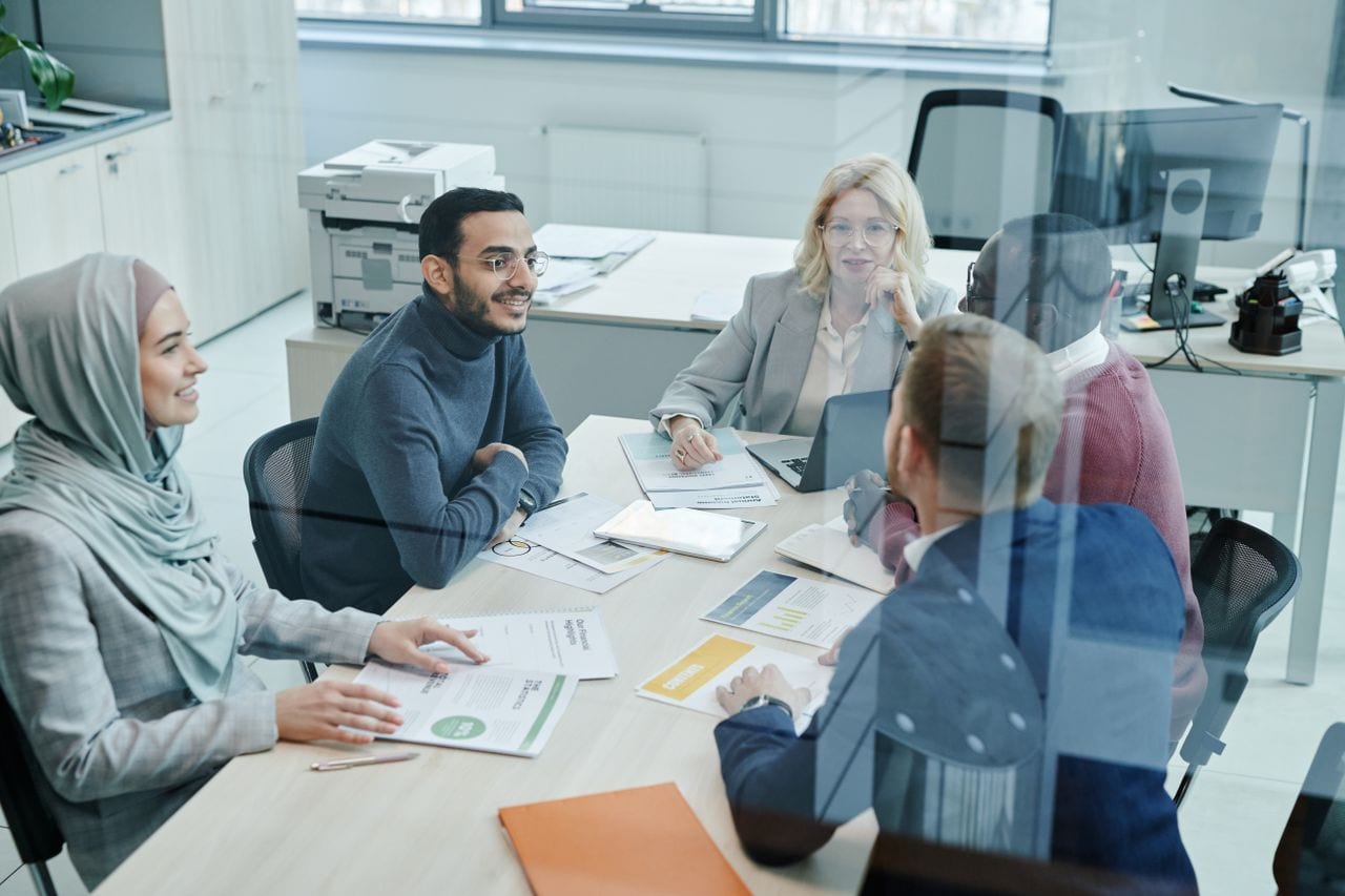 Professional advisors meeting around a conference table in a bright office